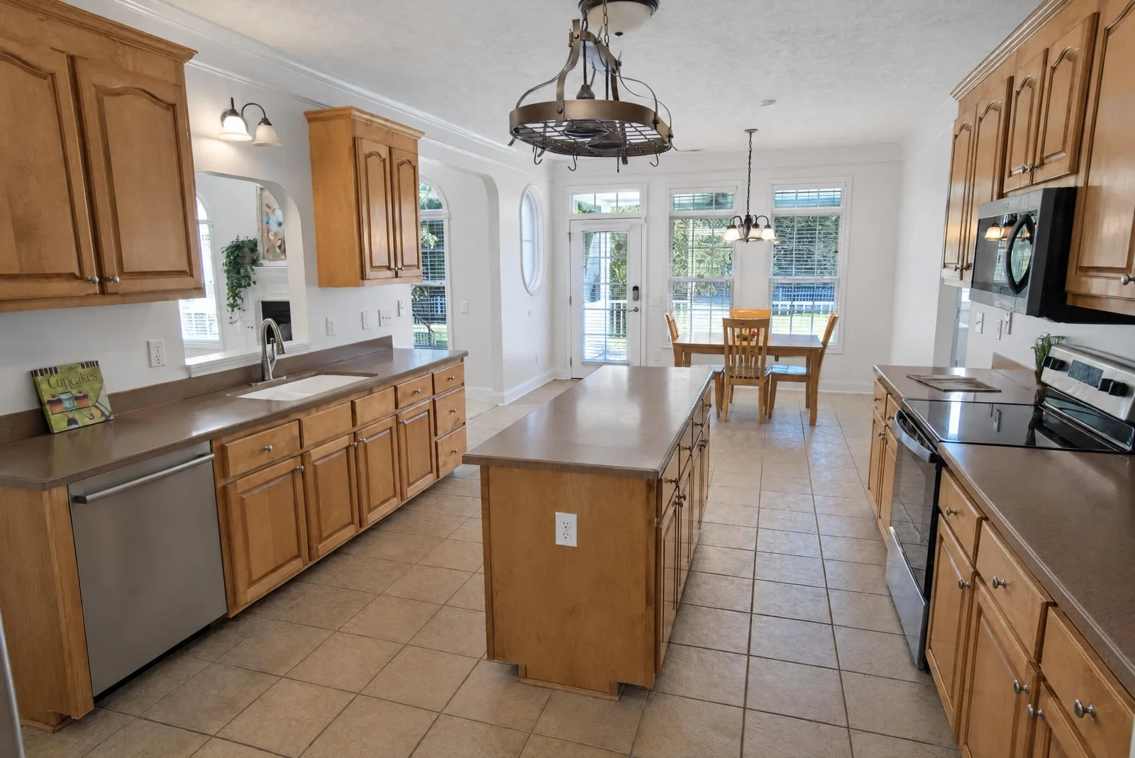 Bright kitchen with an island, maple cabinets and a breakfast nook